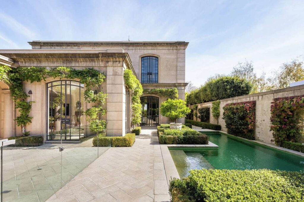 grand old toorak home in melbourne, backyard with pool and vines growing up pillars