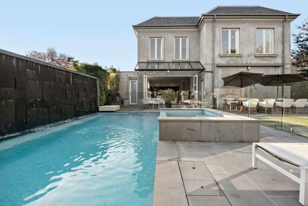 hawthorn mansion with long blue pool and stunning alfresco outdoor area