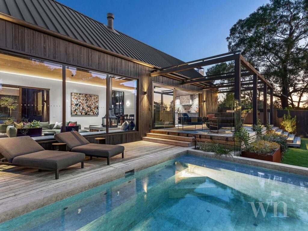 resort style backyard with pool and veranda at sunset in mount martha victoria