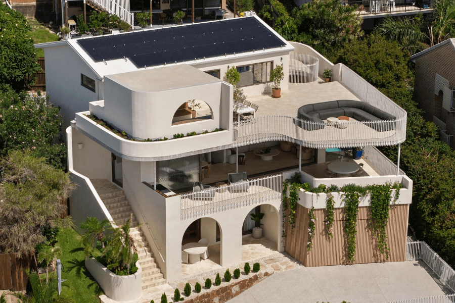 Looking down on multi-level home with vines and curves